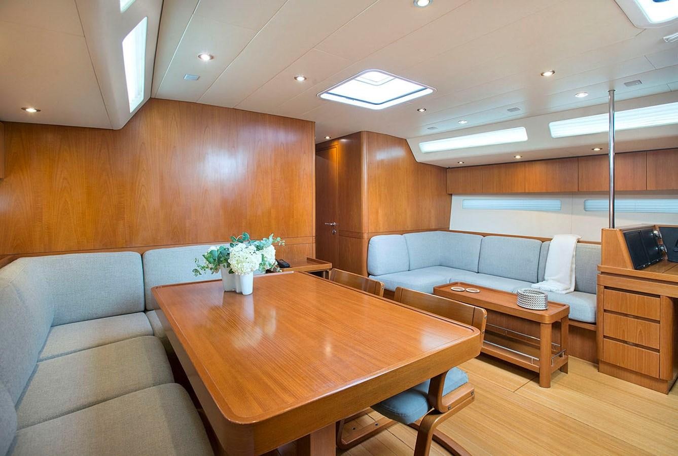 a living room with a couch and a table aboard SALPARE Yacht for Sale