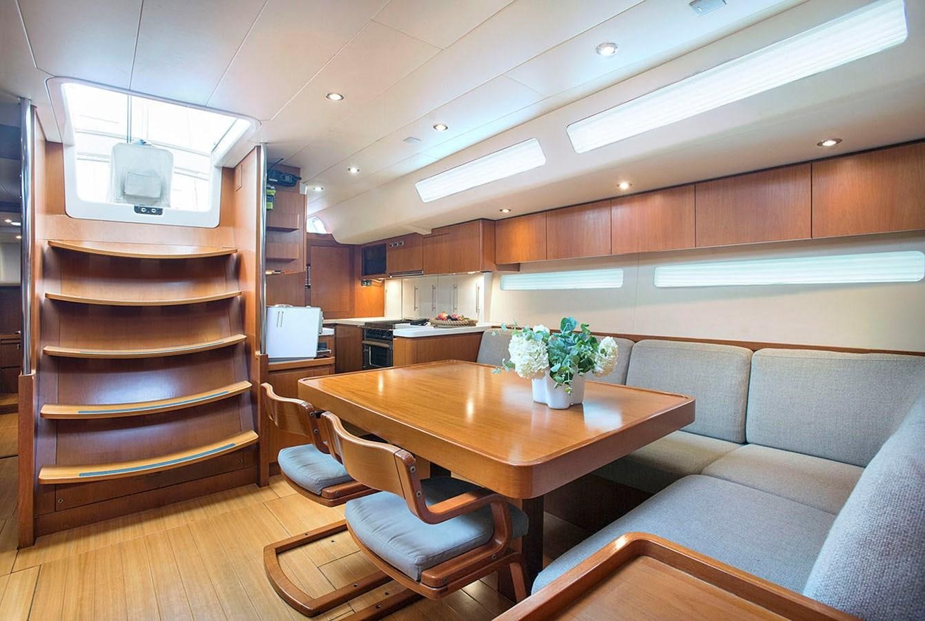 a living room with a couch and a table aboard SALPARE Yacht for Sale