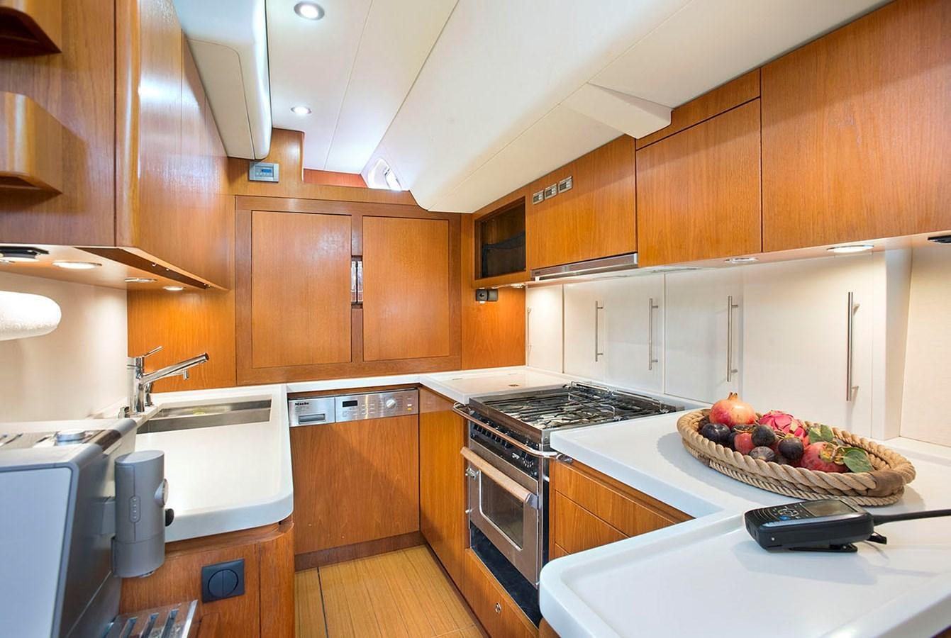 a kitchen with a bowl of fruit on a counter aboard SALPARE Yacht for Sale