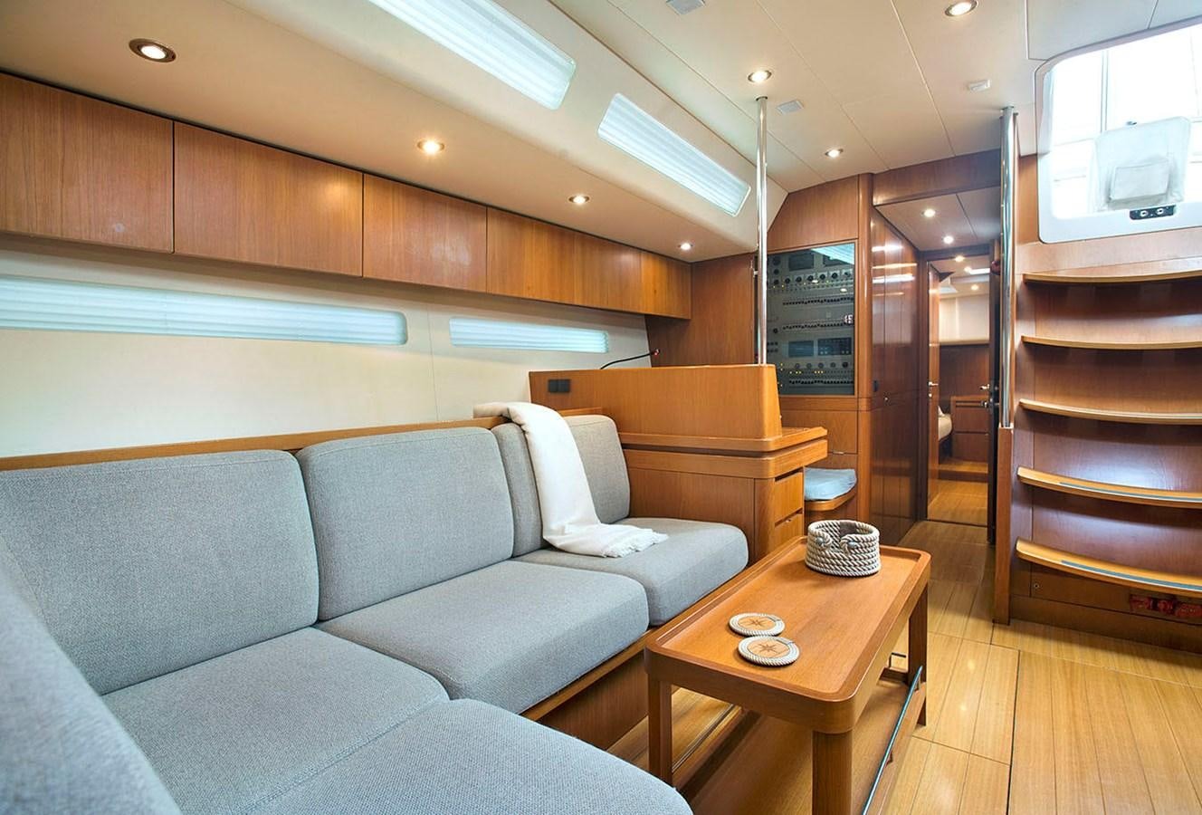 a living room with a couch and a coffee table aboard SALPARE Yacht for Sale