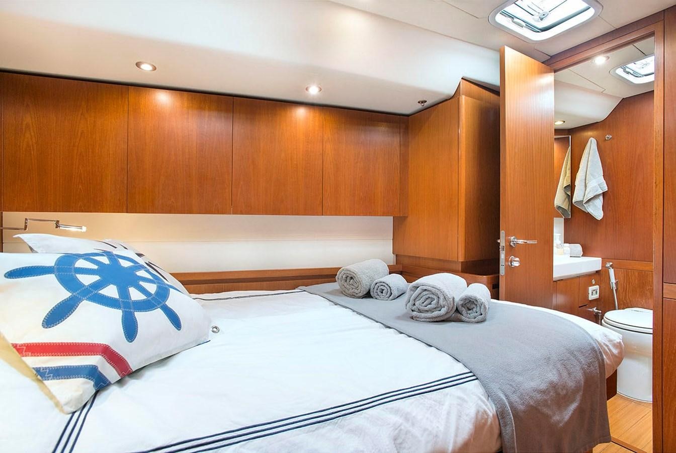 a room with a bed and a closet aboard SALPARE Yacht for Sale