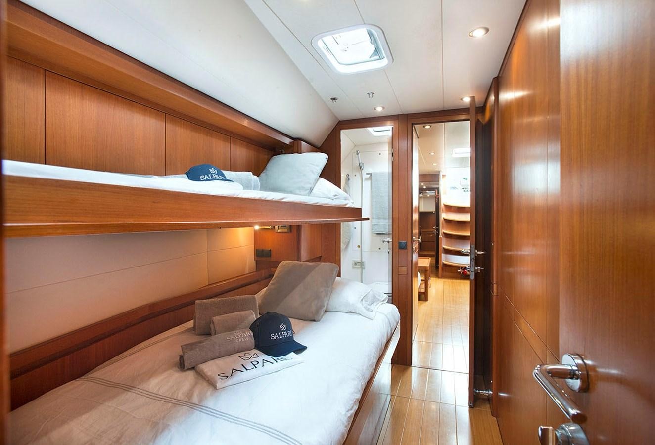 a room with a bed and a desk aboard SALPARE Yacht for Sale