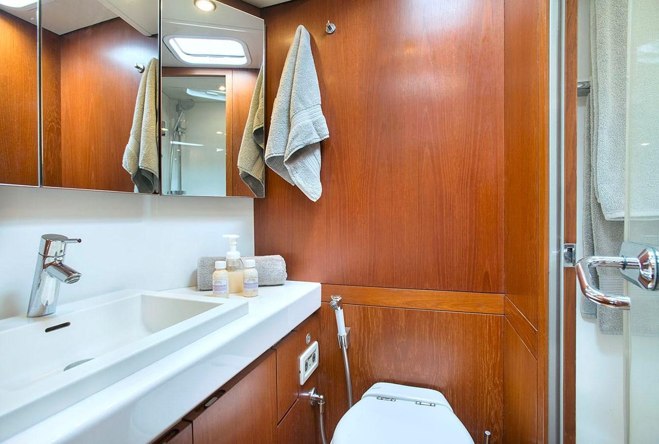 a bathroom with a sink and a toilet aboard SALPARE Yacht for Sale