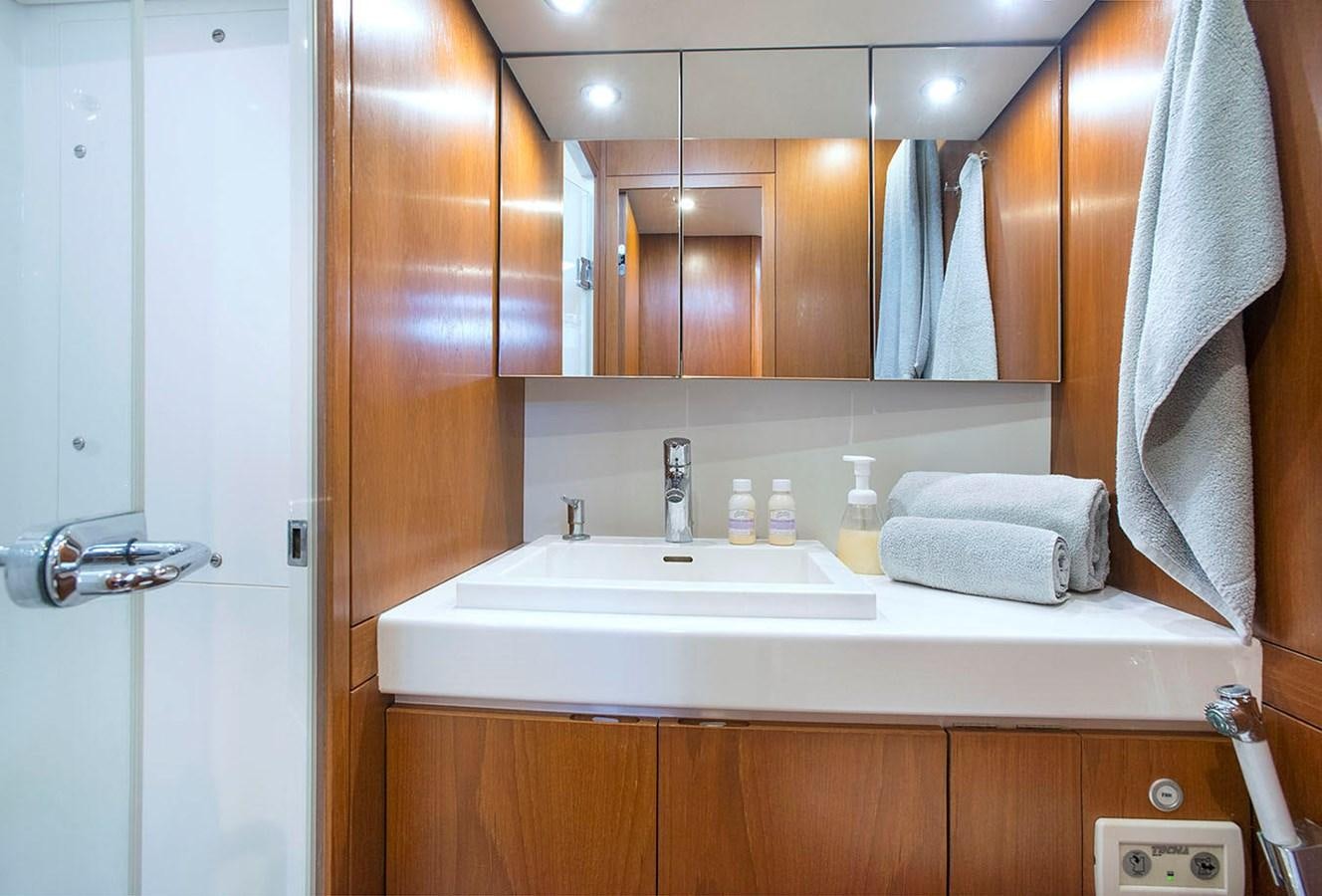 a bathroom with a sink and a mirror aboard SALPARE Yacht for Sale