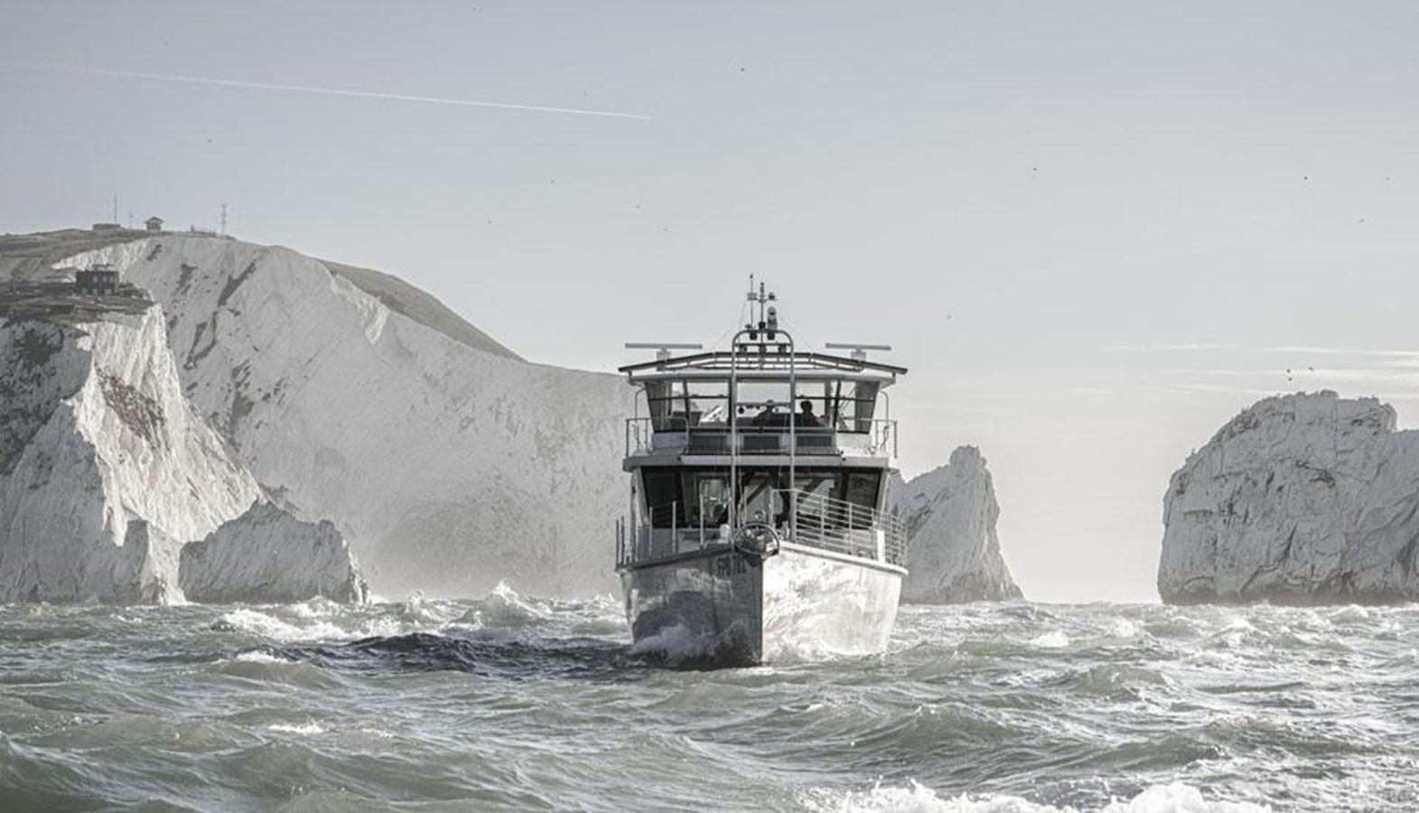 a building on a rock in the sea aboard COCHISE Yacht for Sale