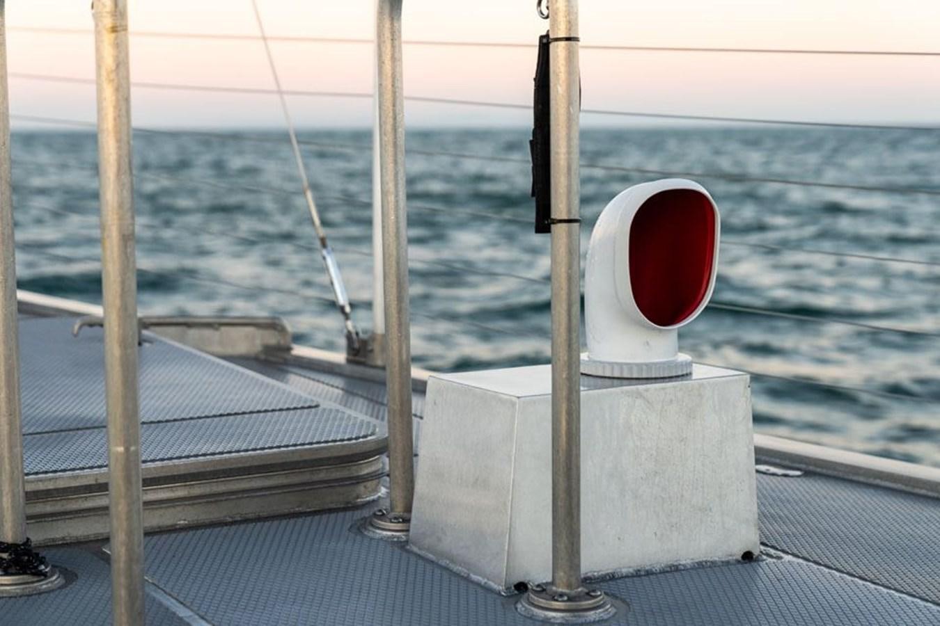 a white post with a red circle on it on a dock by the water aboard COCHISE Yacht for Sale