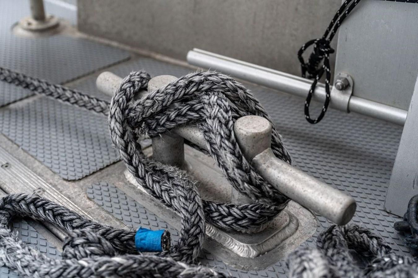 a gloved hand holding a hammer aboard COCHISE Yacht for Sale