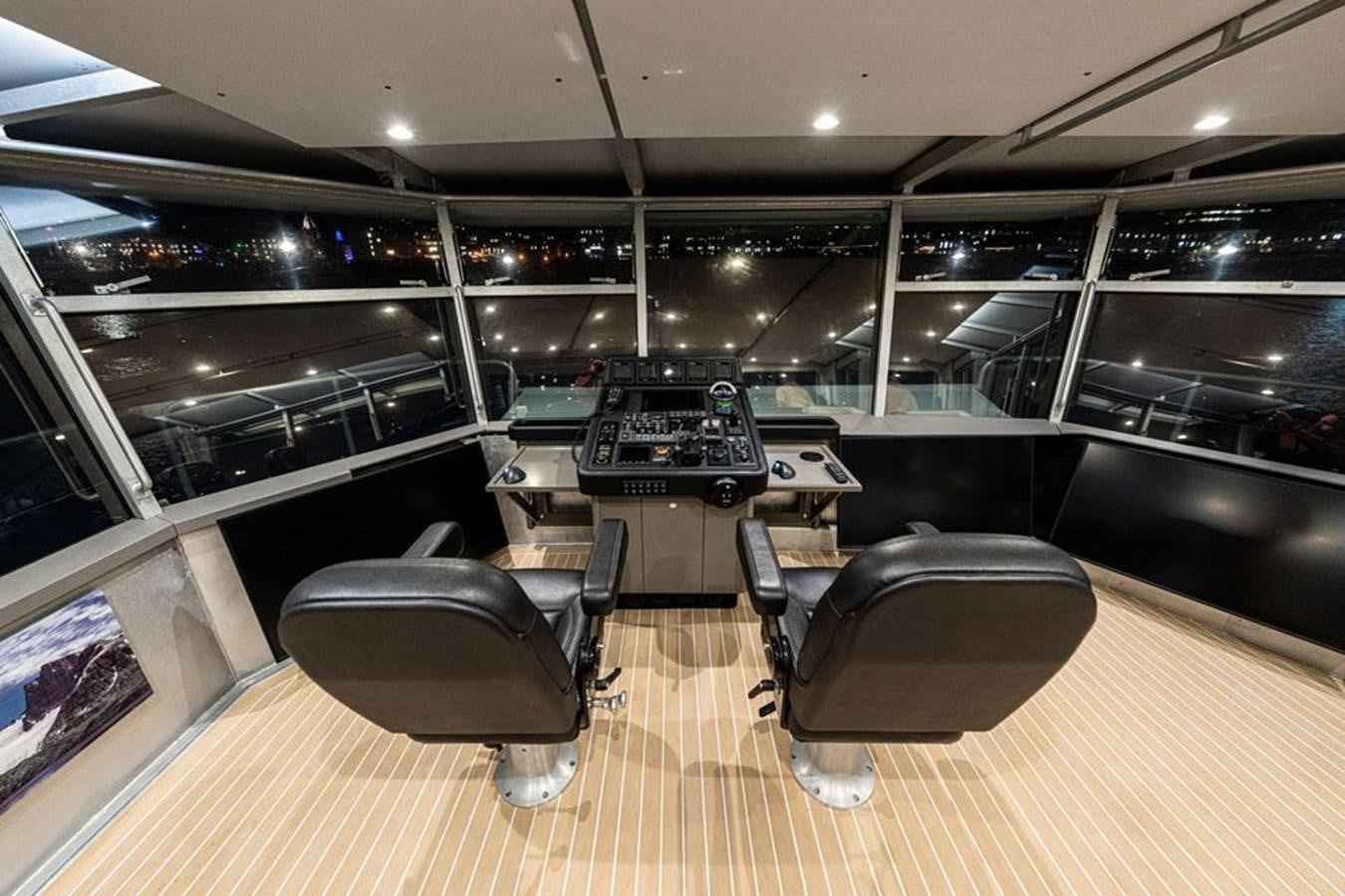 a room with a piano and chairs aboard COCHISE Yacht for Sale