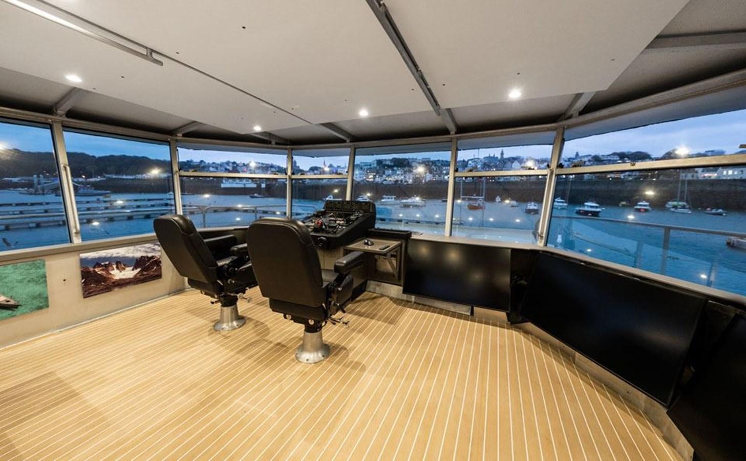 inside of a building with a large window and a wood floor aboard COCHISE Yacht for Sale