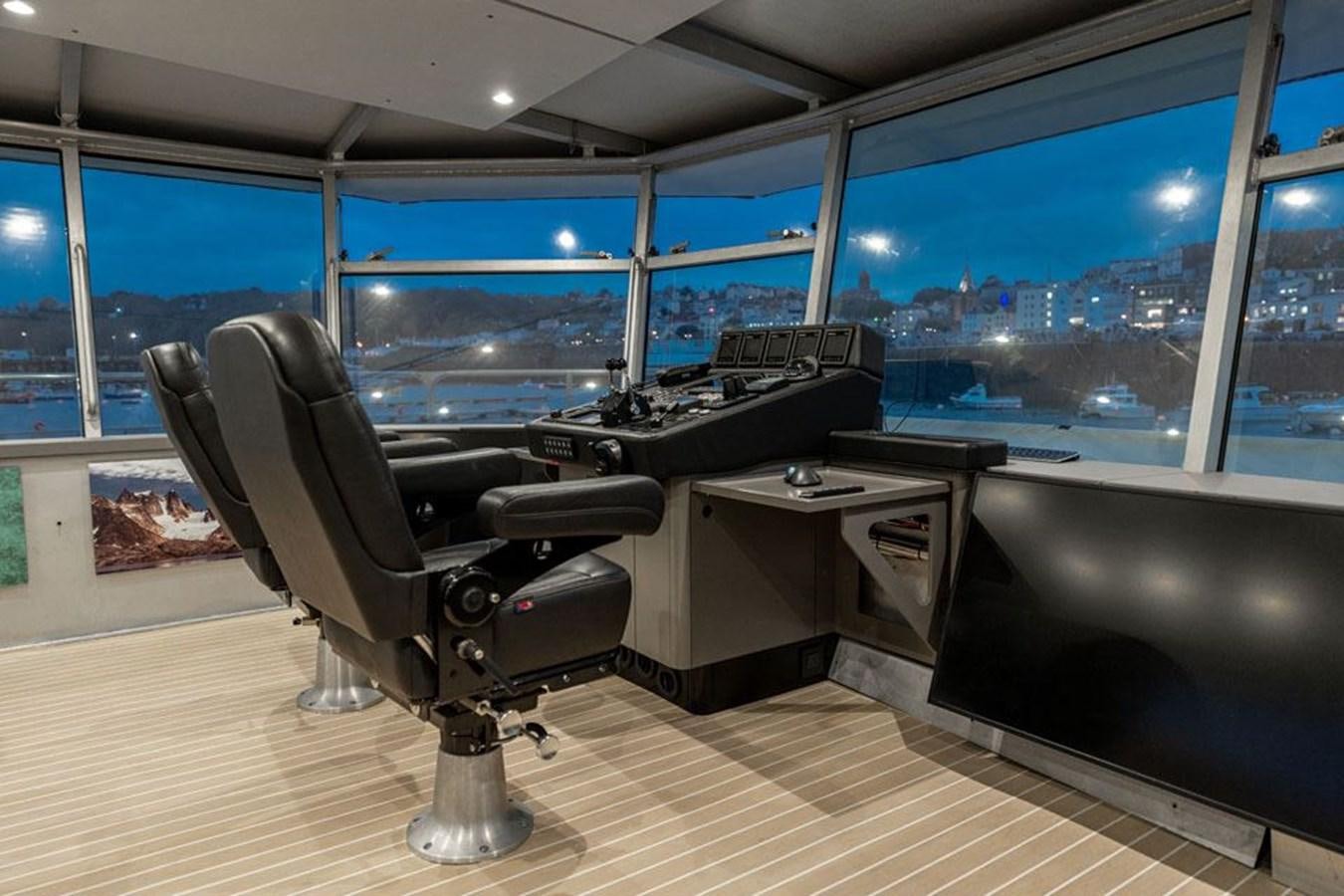 a room with a table and chairs aboard COCHISE Yacht for Sale