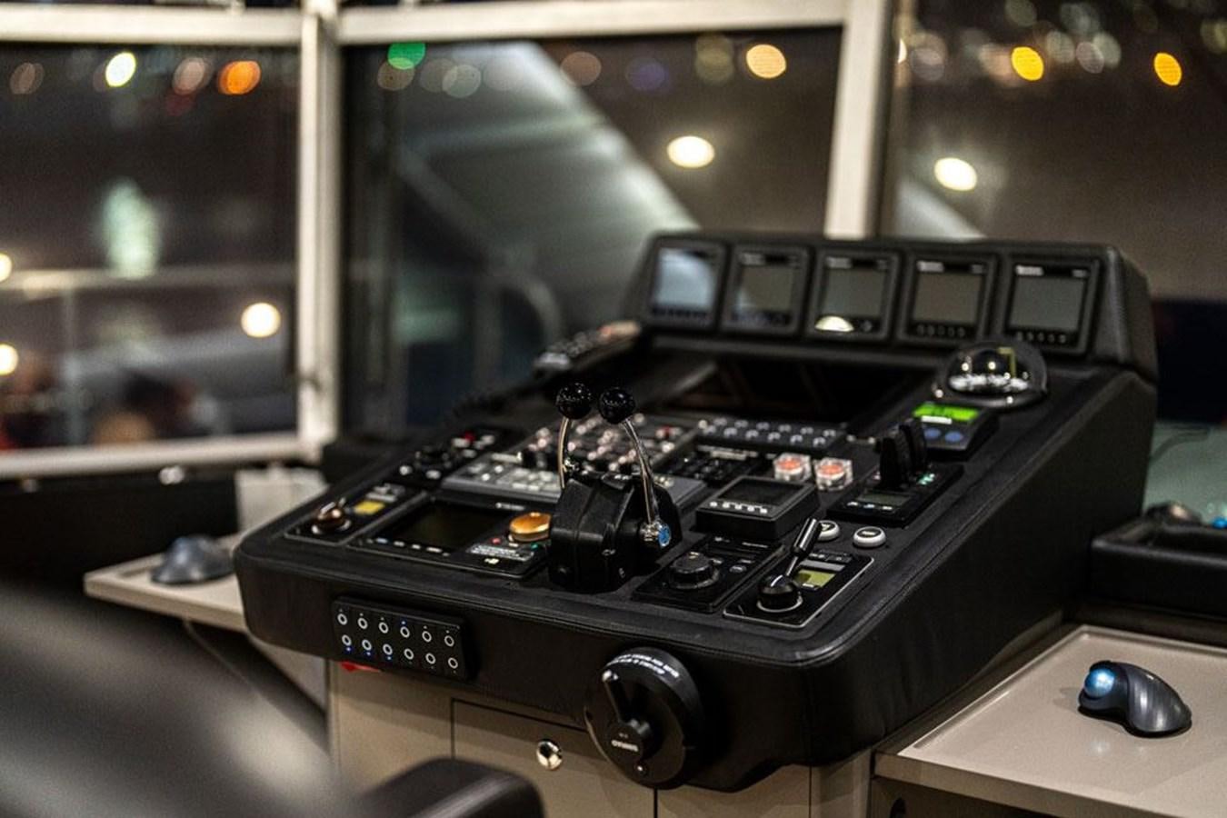 a black rectangular object with a screen and buttons on a wooden surface aboard COCHISE Yacht for Sale
