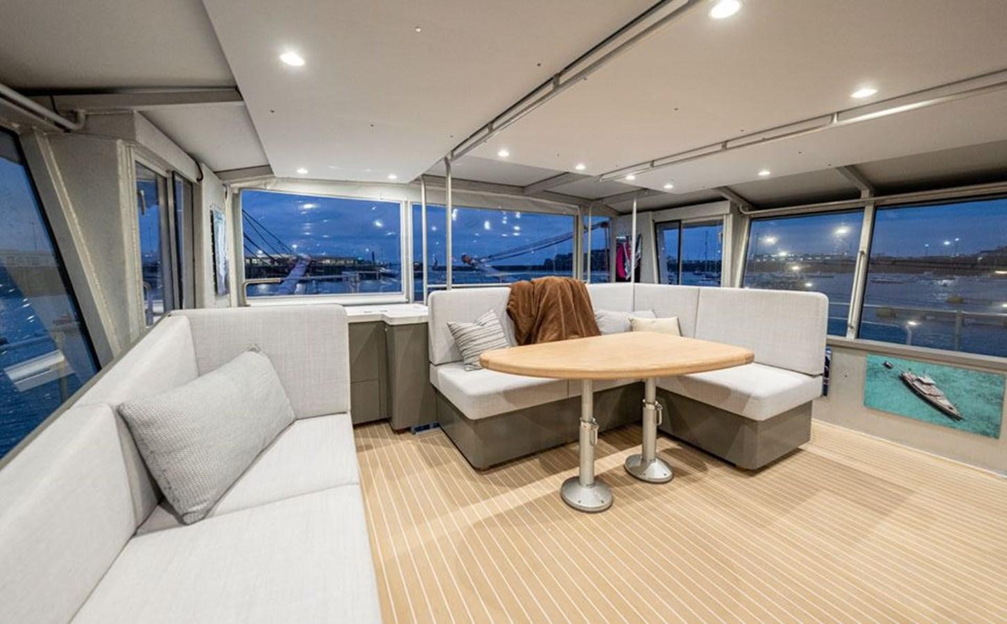a room with couches and a table aboard COCHISE Yacht for Sale