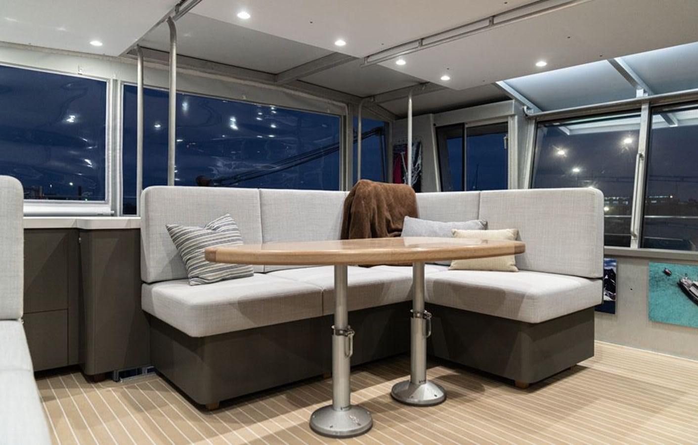 a person sitting on a couch aboard COCHISE Yacht for Sale