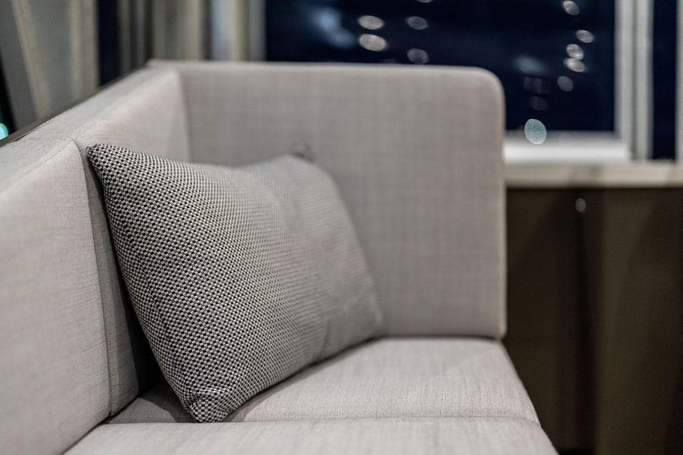 a white couch with a grey pillow aboard COCHISE Yacht for Sale