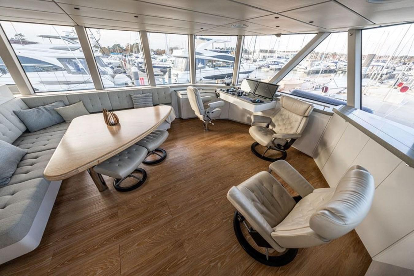 a room with a table chairs and a couch aboard COCHISE Yacht for Sale