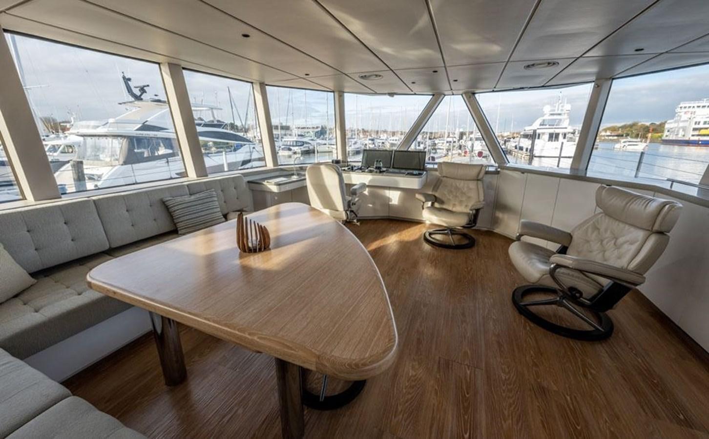 a table and chairs in a room aboard COCHISE Yacht for Sale