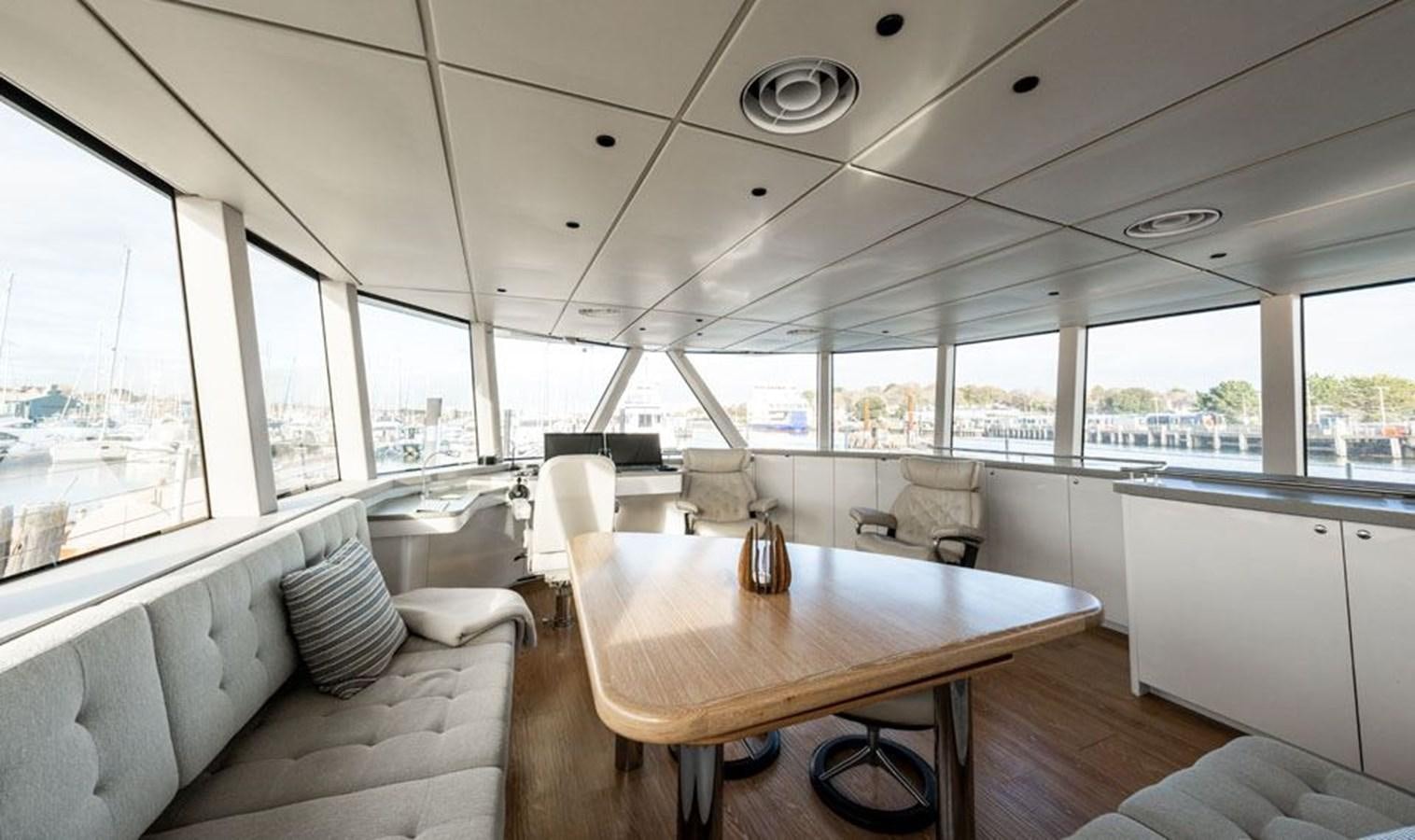 a room with a table and chairs aboard COCHISE Yacht for Sale