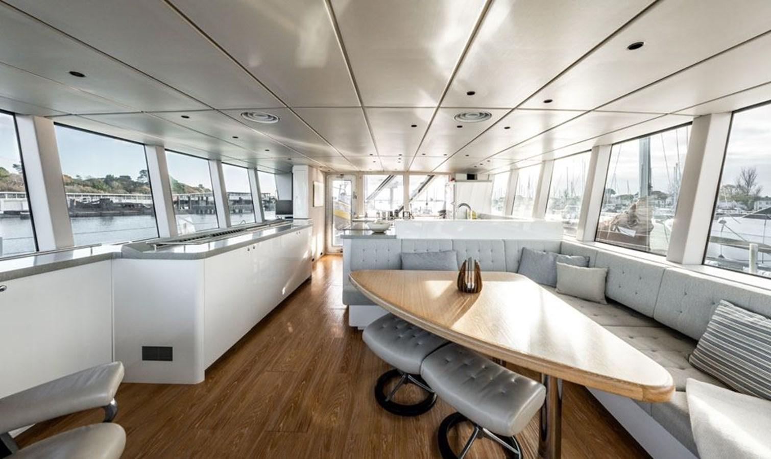 a room with a table and chairs aboard COCHISE Yacht for Sale