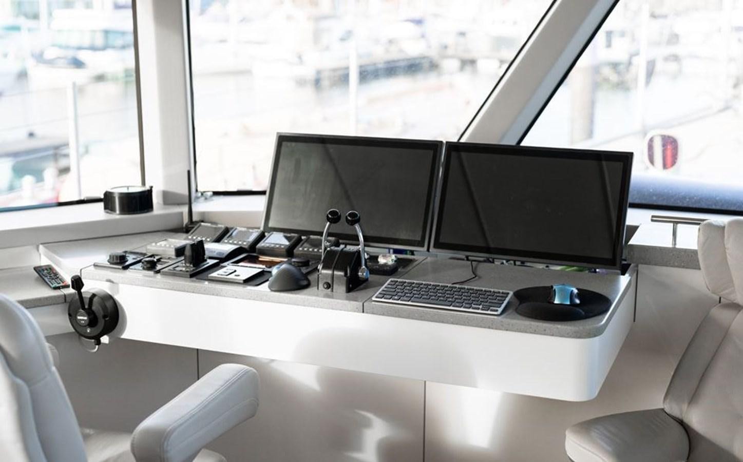 a desk with a computer and a window aboard COCHISE Yacht for Sale