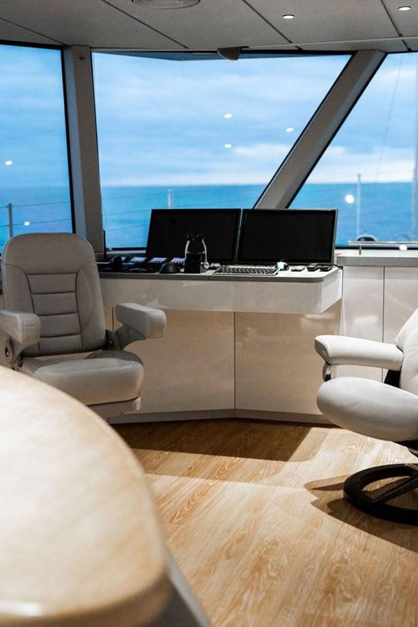 a room with a desk and a chair and a large window aboard COCHISE Yacht for Sale