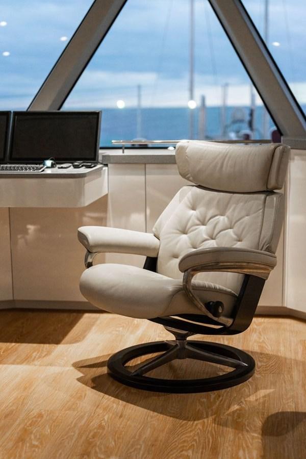 a chair in front of a window aboard COCHISE Yacht for Sale