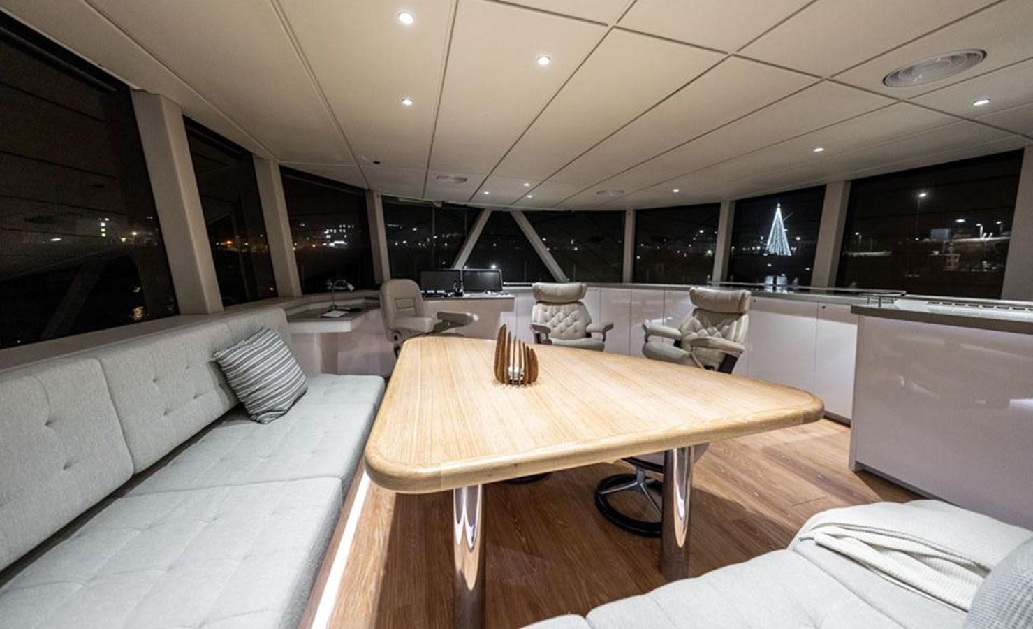 a room with a table and chairs aboard COCHISE Yacht for Sale