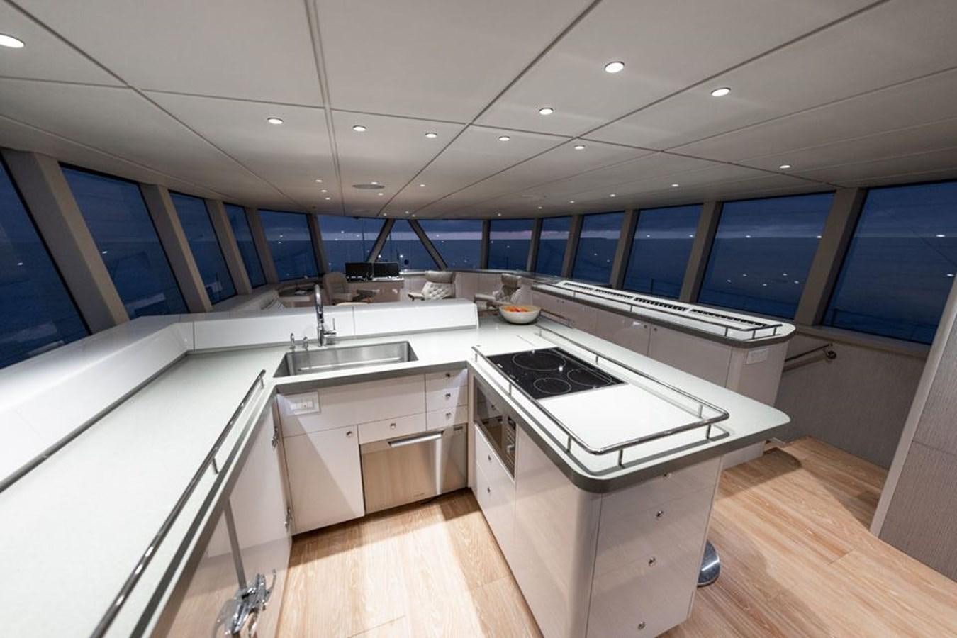 a kitchen with a large island aboard COCHISE Yacht for Sale