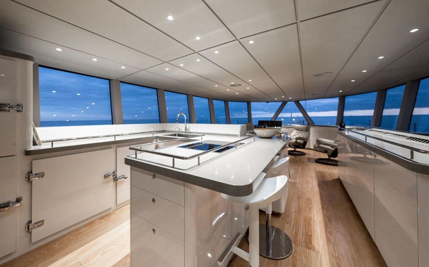 a room with a large table and chairs aboard COCHISE Yacht for Sale