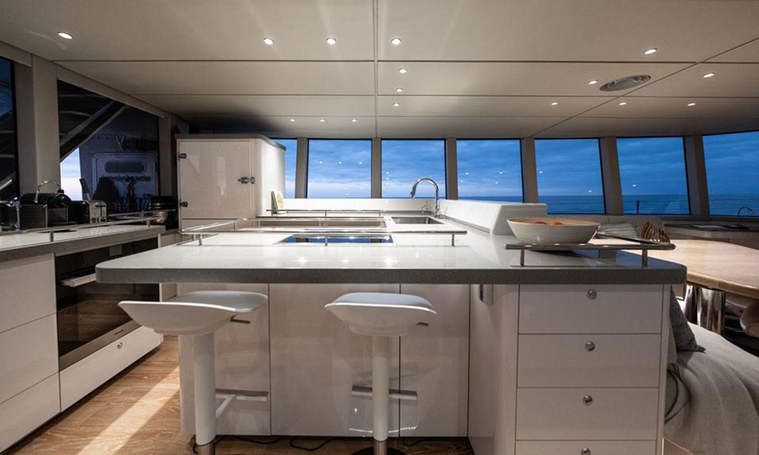 a kitchen with white cabinets aboard COCHISE Yacht for Sale