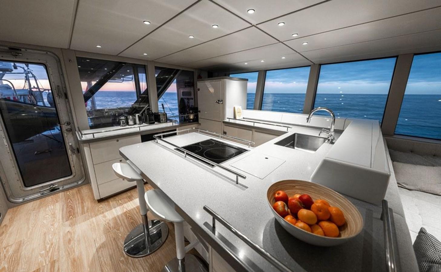 a kitchen with a bowl of fruit aboard COCHISE Yacht for Sale