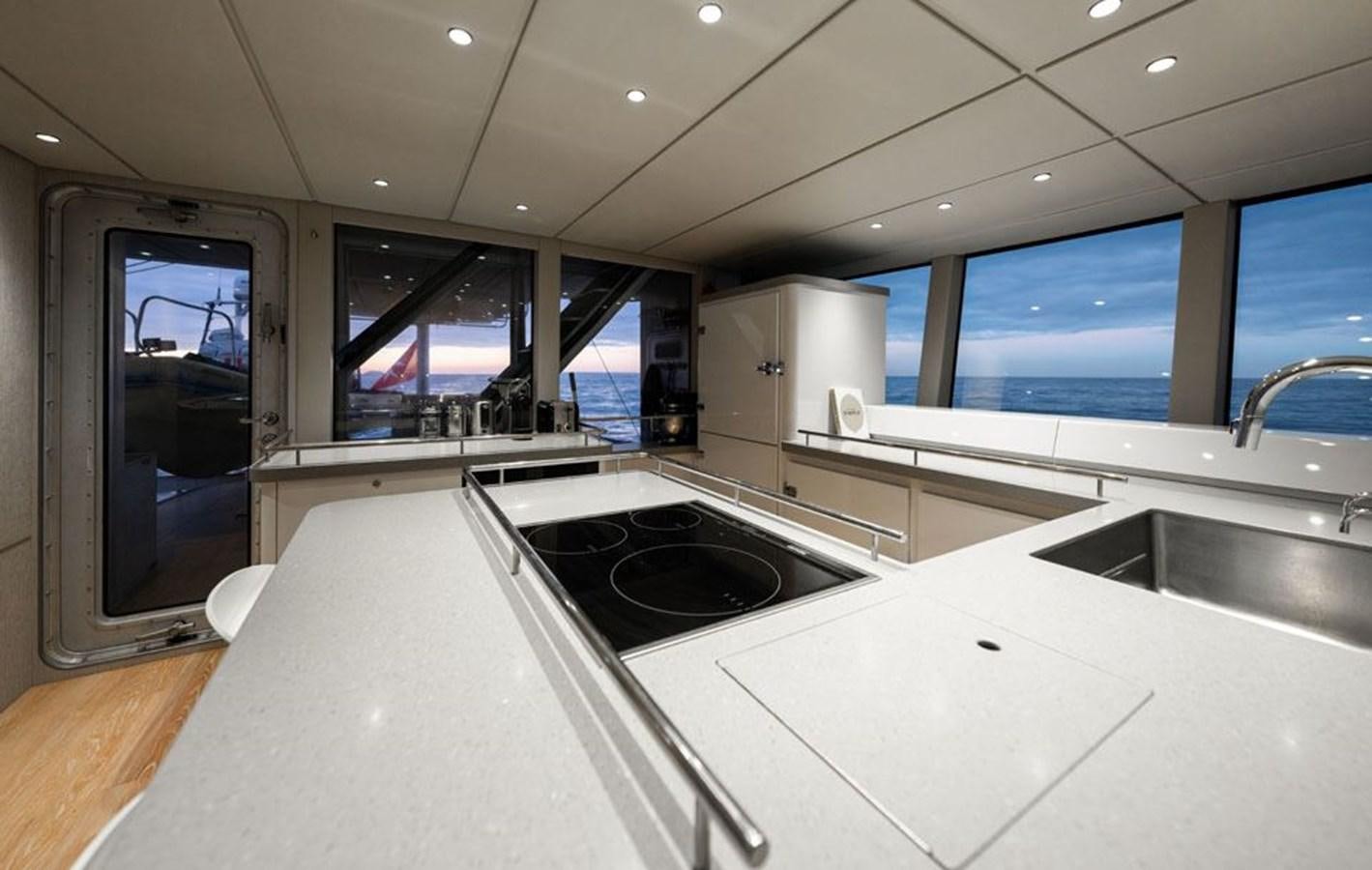 a kitchen with a large island aboard COCHISE Yacht for Sale