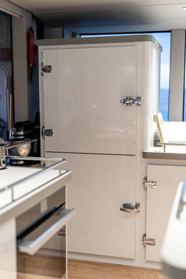 a white refrigerator in a kitchen aboard COCHISE Yacht for Sale