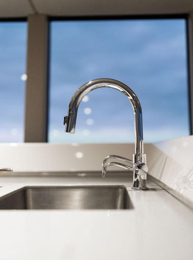 a bathroom sink with a blue window aboard COCHISE Yacht for Sale