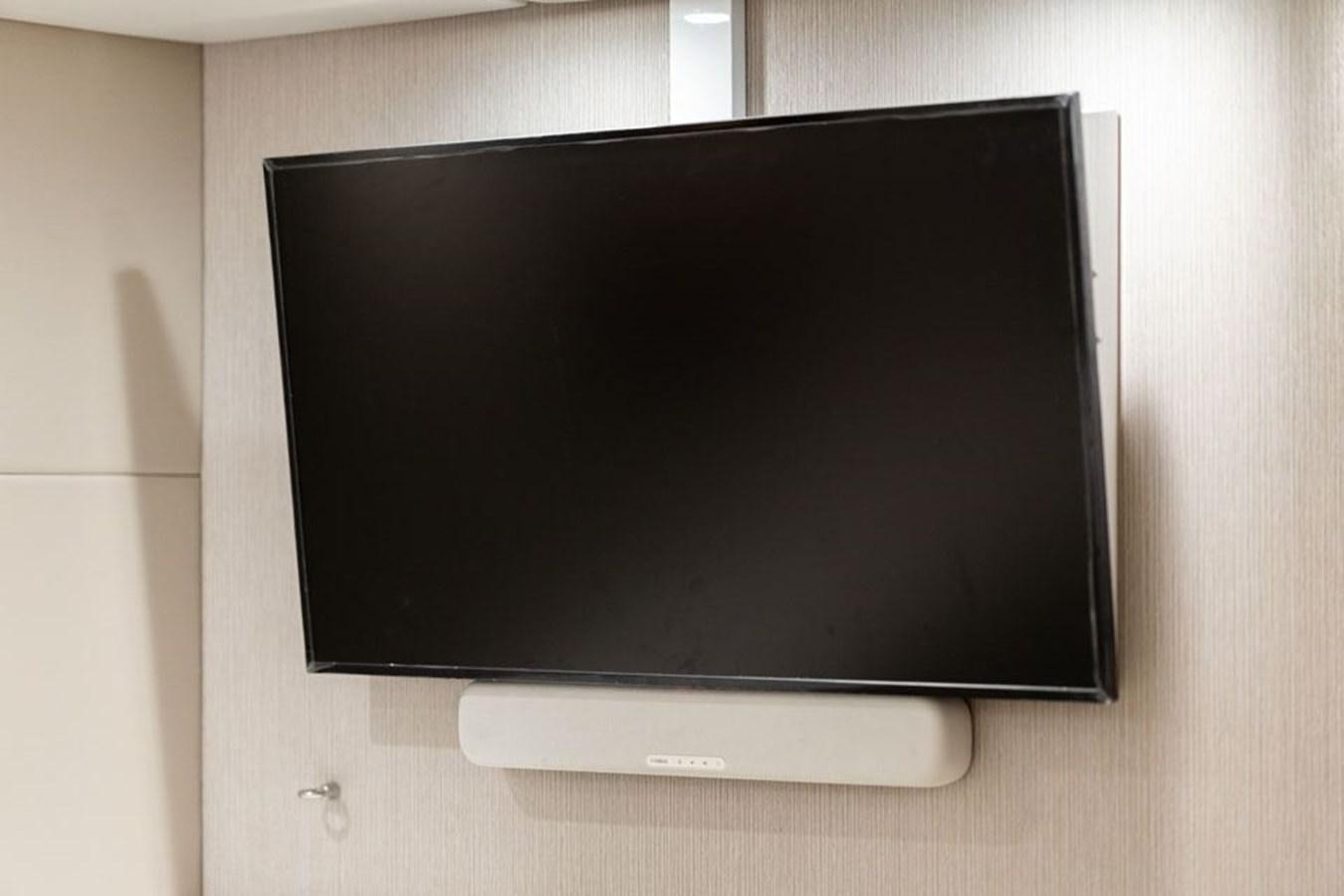 a black television on a white wall aboard COCHISE Yacht for Sale