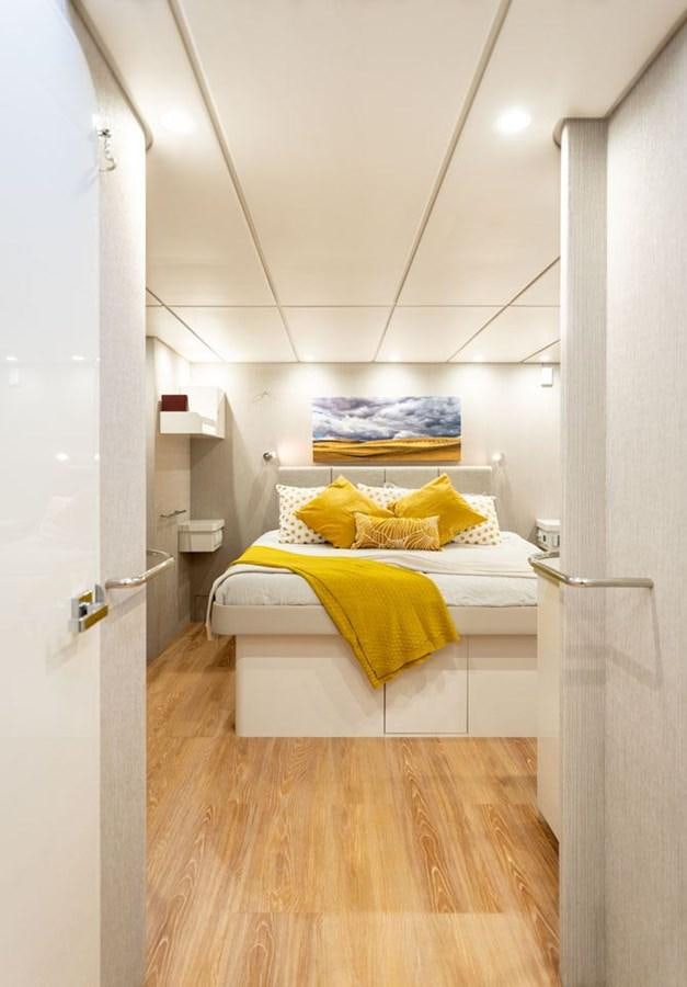 a bedroom with a bed aboard COCHISE Yacht for Sale