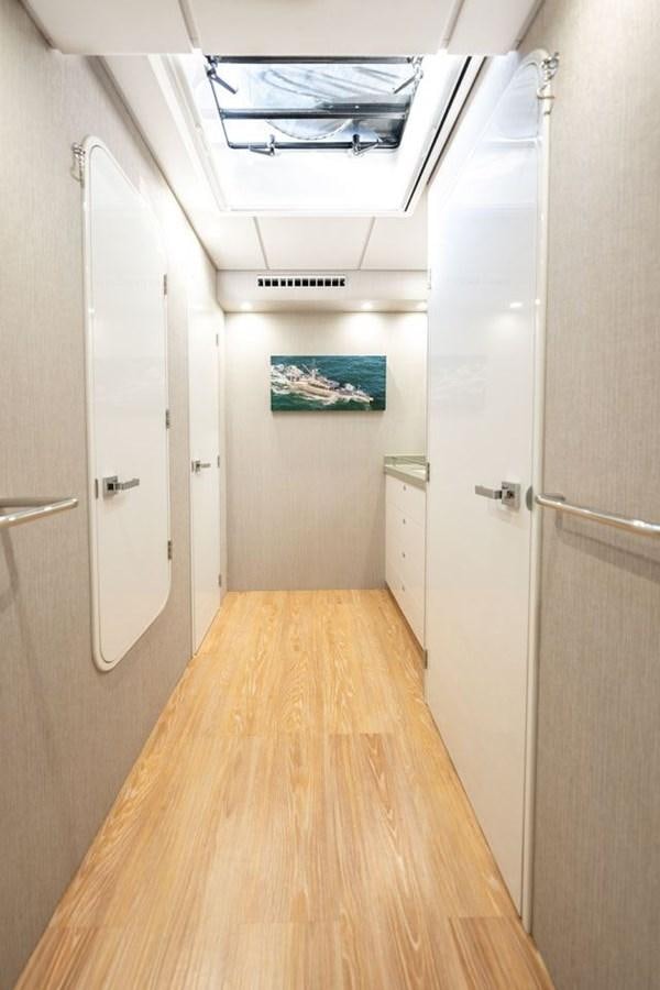 a hallway with white doors aboard COCHISE Yacht for Sale