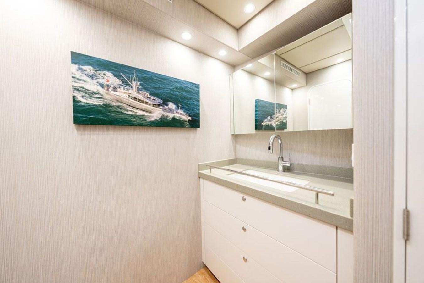 a bathroom with a sink and a mirror aboard COCHISE Yacht for Sale