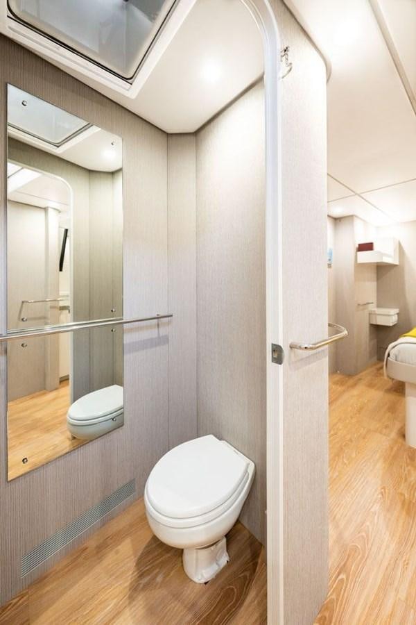a bathroom with a glass shower aboard COCHISE Yacht for Sale