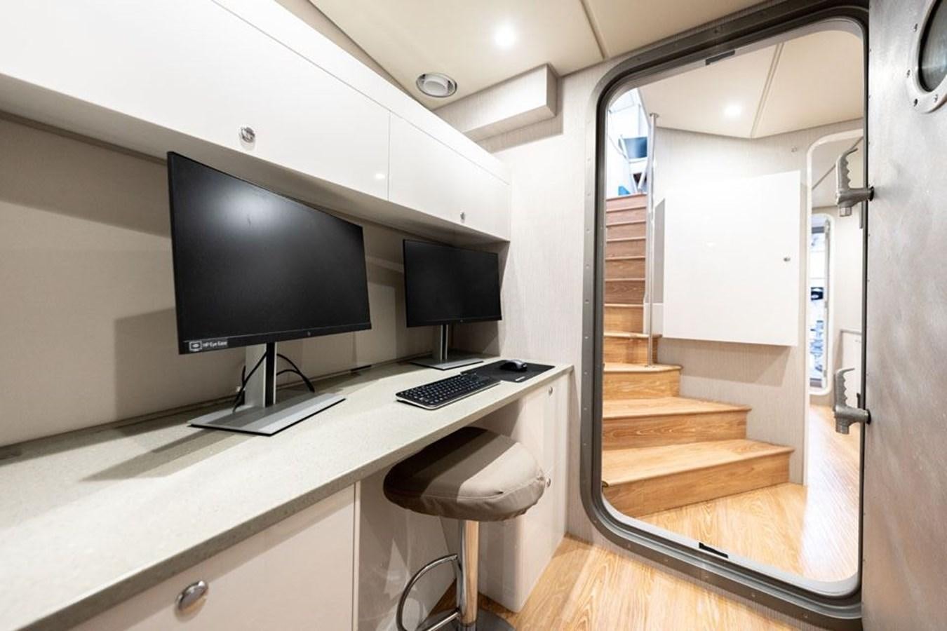 a desk with a computer aboard COCHISE Yacht for Sale