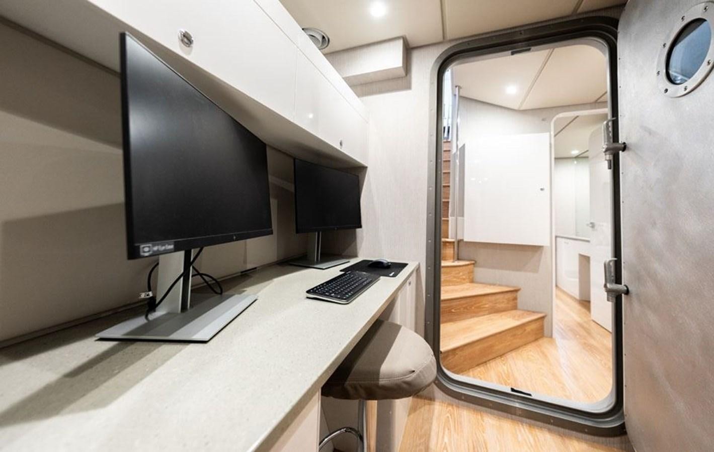 a room with a desk and a tv aboard COCHISE Yacht for Sale