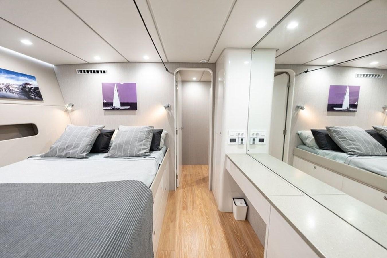 a room with beds and a wood floor aboard COCHISE Yacht for Sale