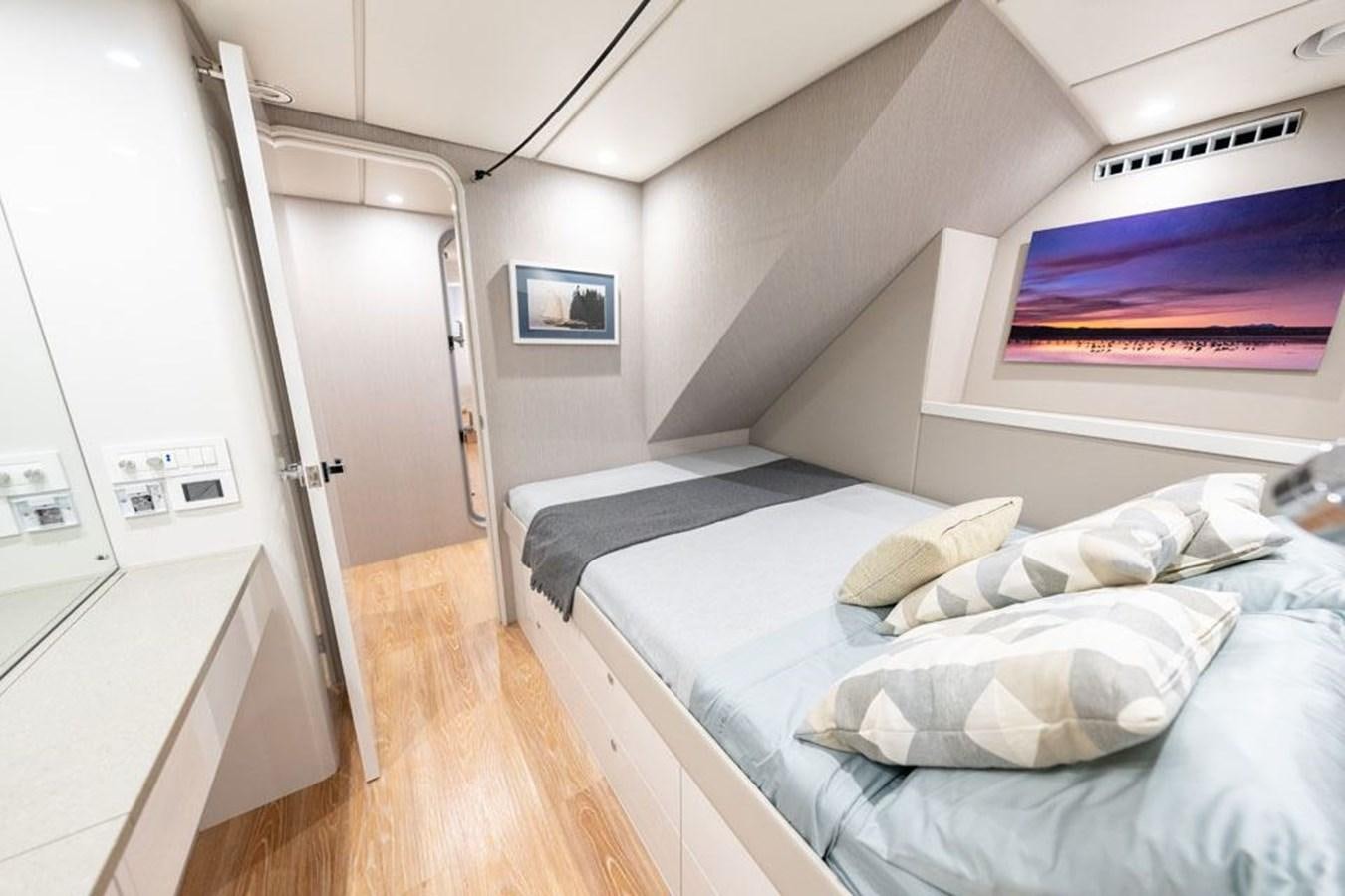 a room with a bed and a desk aboard COCHISE Yacht for Sale