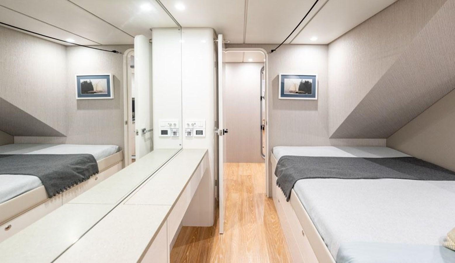 a room with a bed and a television aboard COCHISE Yacht for Sale