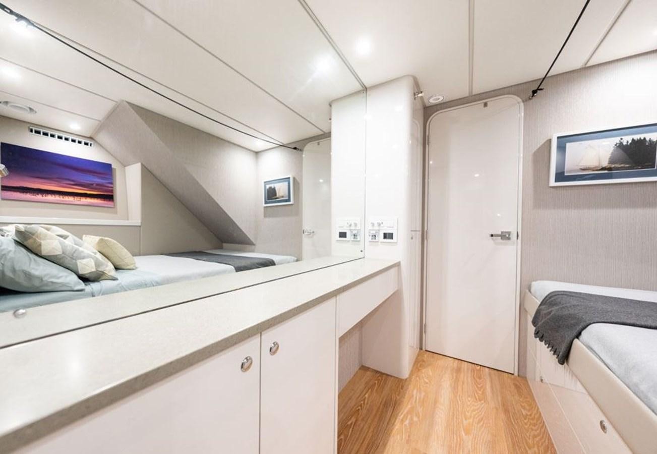 a room with a bed and a desk aboard COCHISE Yacht for Sale