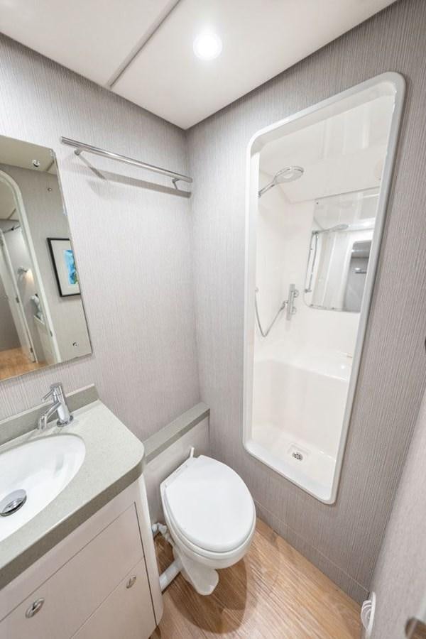 a bathroom with a toilet and a sink aboard COCHISE Yacht for Sale