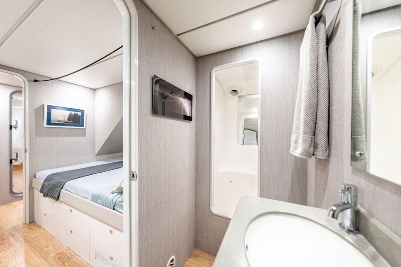 a bathroom with a sink and a mirror aboard COCHISE Yacht for Sale