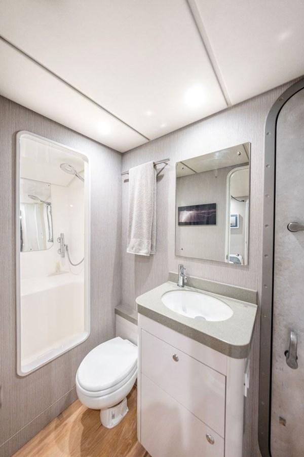 a bathroom with a sink toilet and shower aboard COCHISE Yacht for Sale