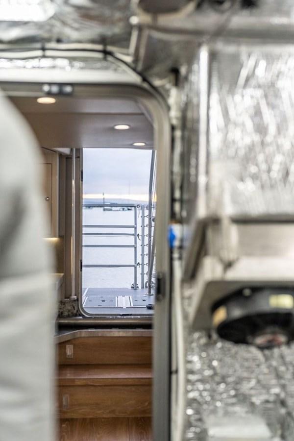a room with a door and a window aboard COCHISE Yacht for Sale