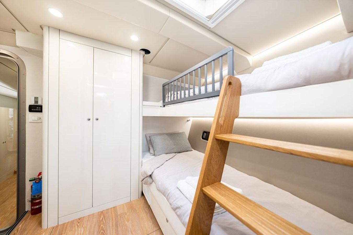 a room with bunk beds aboard COCHISE Yacht for Sale