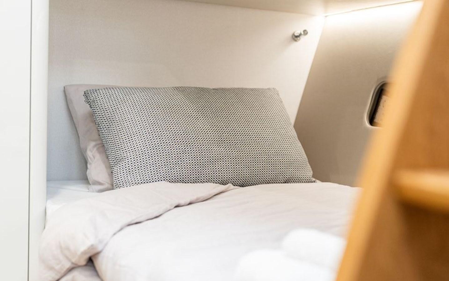 a pillow on a bed aboard COCHISE Yacht for Sale